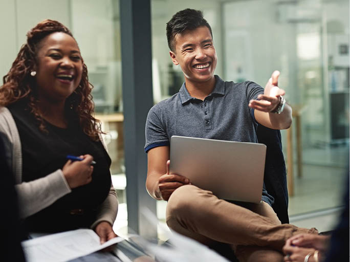 Shot of a group of businesspeople sitting in a circle while having a meeting